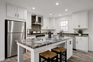 Aspire's large kitchen with center island, appliances, and beautiful cabinets